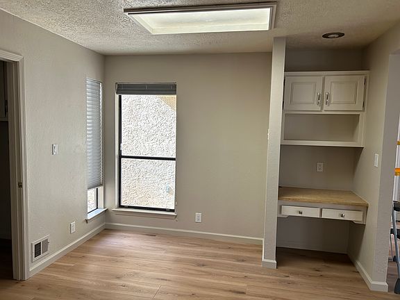 Kitchen with space for table as well as a work nook. Laundry room and pantry to the left.