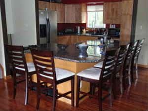 upgraded kitchen with granite countertops, wood floors & stainless steel appl