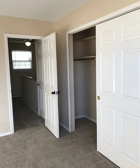 Picture of bedroom 2 close and hallway area.
