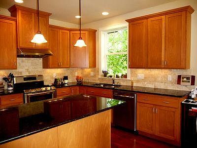 Kitchen has a double oven gas range, microwave, refrigerator, dishwasher, and ample storage.