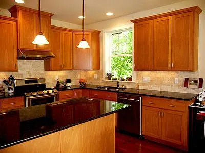Kitchen has a double oven gas range, microwave, refrigerator, dishwasher, and ample storage.