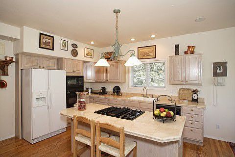 Gourmet kitchen with travertine countertops & center island