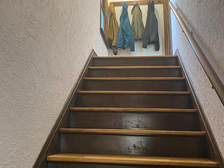 Refinished stairs leading to 2nd floor apartment.