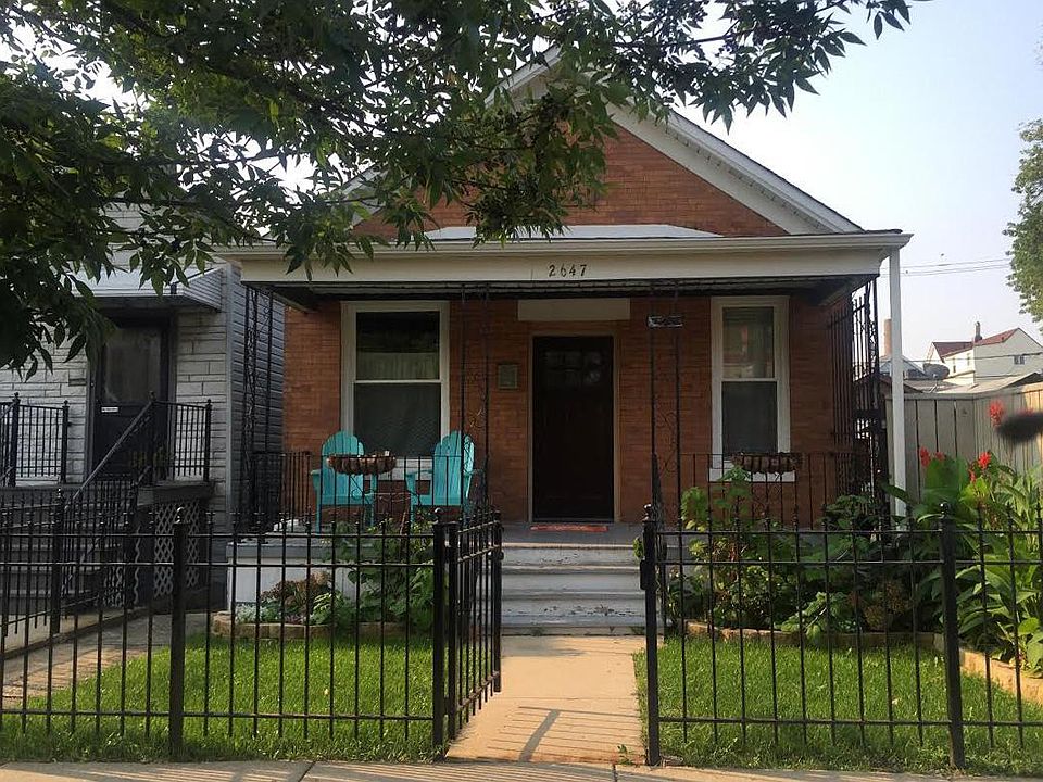 Front yard with covered porch and Adirondack patio chairs fo