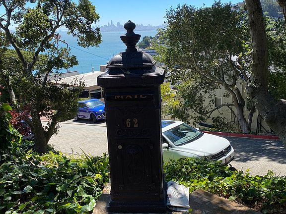 Mailbox and top of walkway to apartment with City view