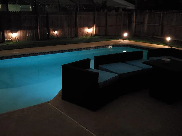 Private fenced backyard with an in-ground pool, patio deck, and built-in seating for outdoor relaxing and entertaining.