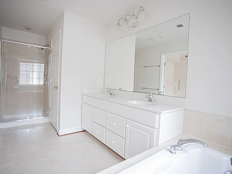 Spa-like master bathroom with double vanities, lots of storage, oversized mirror, dreamy bathtub and a separate shower (brand new shower door and shower head)