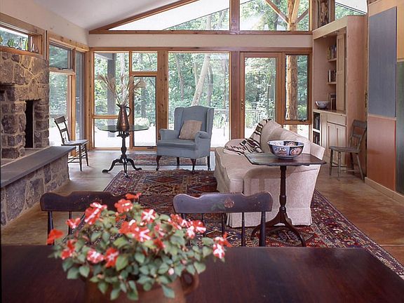 Living room, looking out to covered patio and Lake Roland Park.