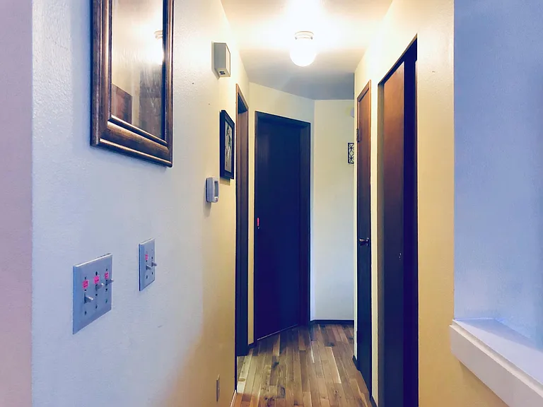 Hallway view _ bathroom is first door on the left and the other two bedrooms are at the end to the left and right.