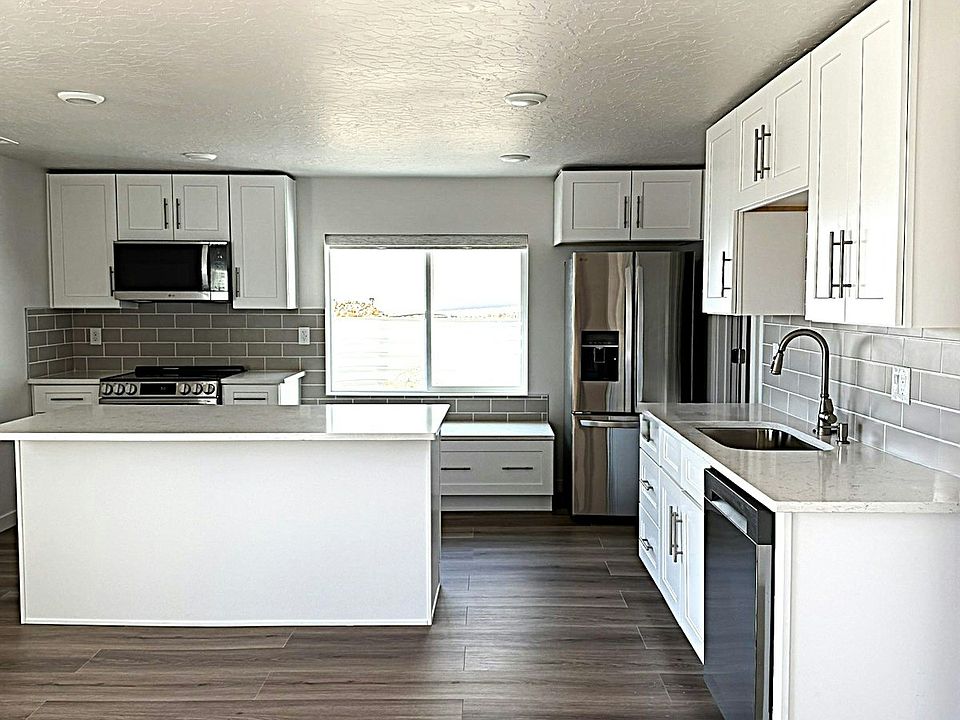 Kitchen with brand new Stainless Steel appliances, White Cabinets , Quartz Countertops , Steel Sink with Faucet