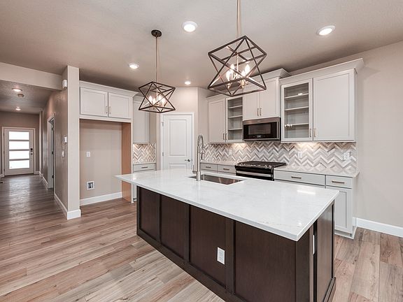 The Snowberry s designer decorated kitchen spills into the dining room allowing for an open feel.