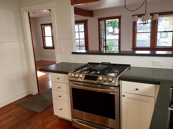 kitchen view of dining/living & deck/yard