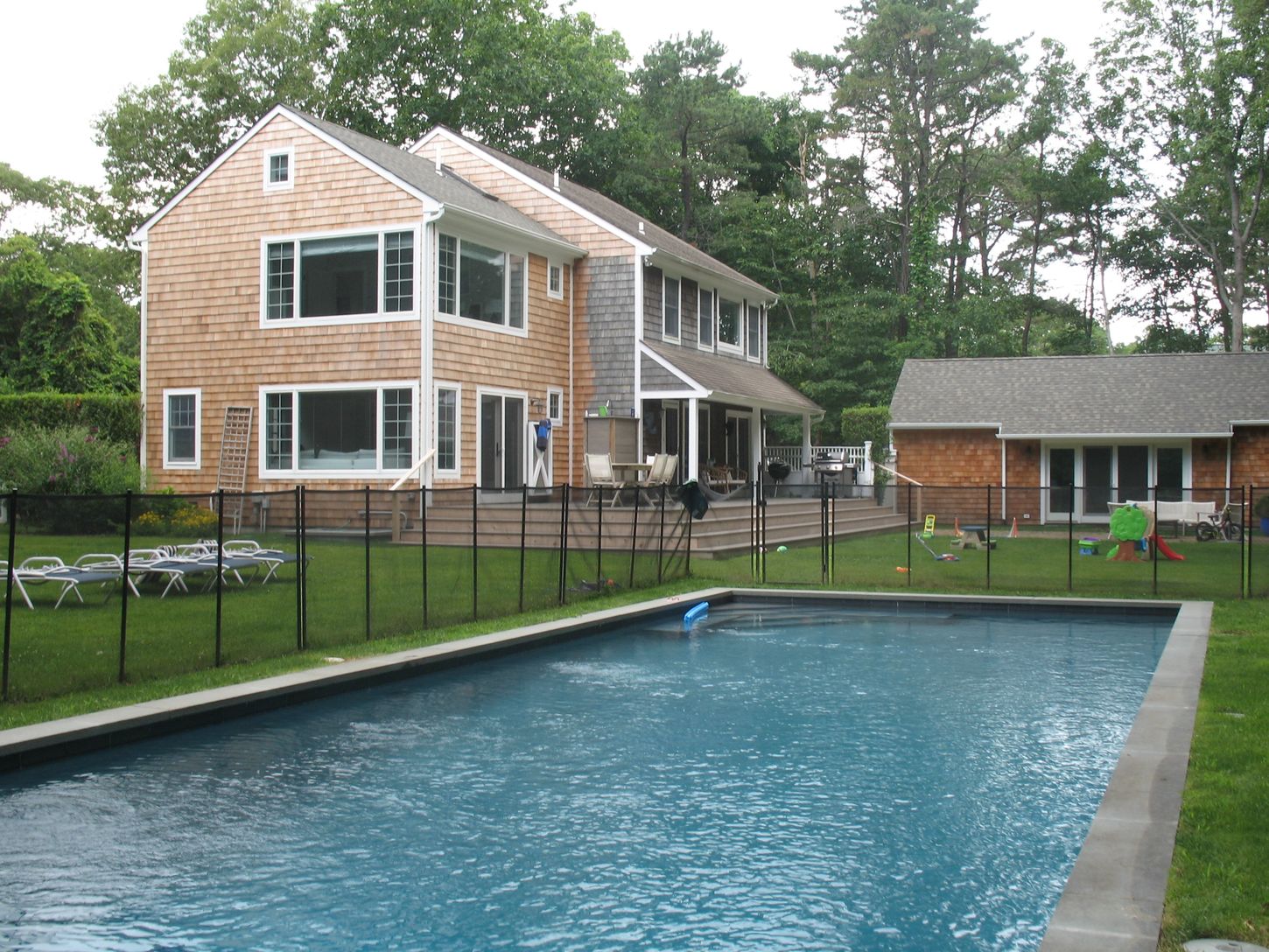  Deck with dining, BBQ, outside shower and pool house overlooks heated pool