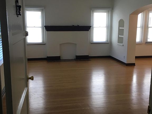 Apartment door opens into spacious living room.