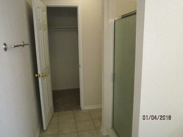 Master Bath shower, toilet area & large walk-in closet.