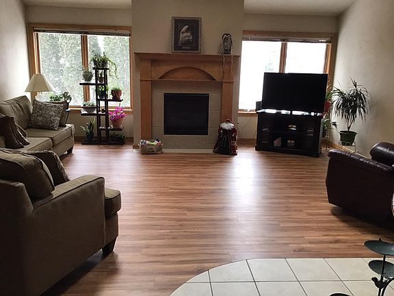 Living room with new laminate flooring and gas FP