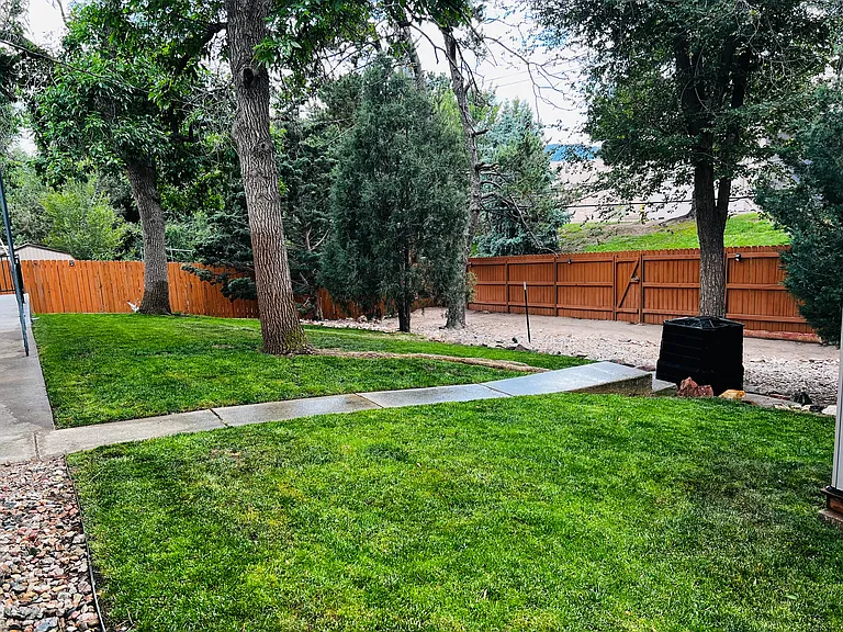 Fully fenced backyard offering plenty of open space and added privacy for guests and pets.