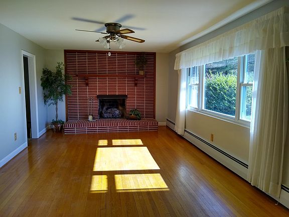 Large living room with gas logs and oak hardwood floors