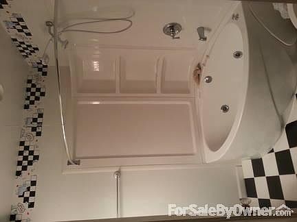 Main Floor Bathroom remodeled in 2010
						:
						Corner jacuzzi tub with shower. Ceramic tile floor. Full mirror above sink.