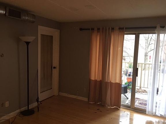 Living room with door to DEN and large balcony