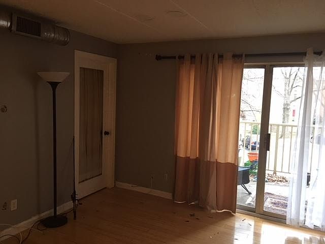 Living room with door to DEN and large balcony