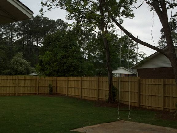 Newly installed privacy fence makes relaxing in the backyard peaceful & quiet.