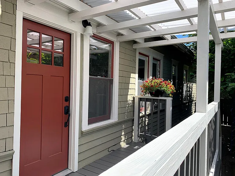 Private entrance with bright covered front porch, perfect for morning coffee.