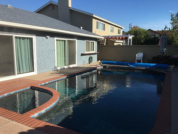 Beautiful jacuzzi and pool with pebble finish.