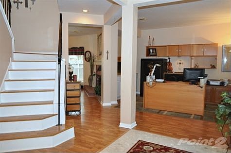 Just inside the entry is a formal living area. Currently being utilized as a study, it has a view of