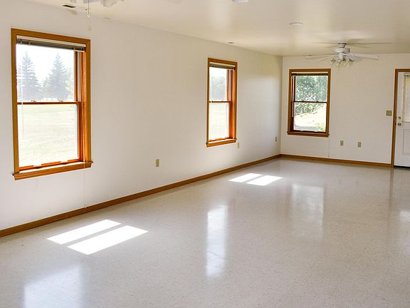 Open dining room that leads to fenced in backyard 