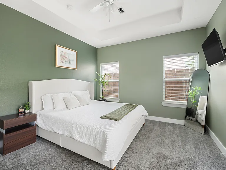 Bedroom 3 features a private full-length mirror, TV, and generous closet space.