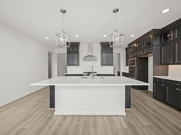 Kitchen with brushed nickel pendant lighting