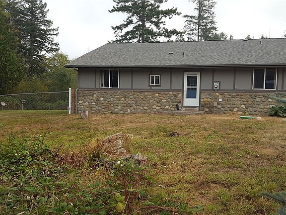 Another View Of Front Of Home; Partially Fenced Area (With Invisible Fencing Throughout Property For All Your Critters). Over 1.10 Acres With Outdoor Shed (w/Electricity) Garden Space & Fruit Trees; Shared Pond In Front Of Home.