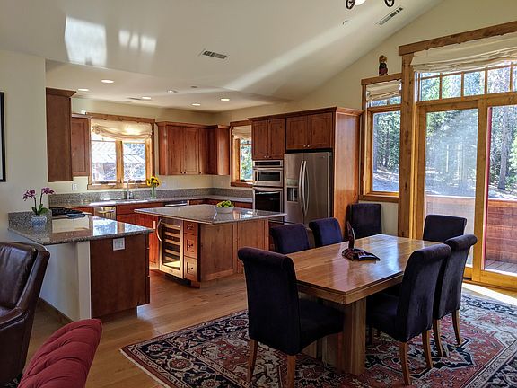 Kitchen and dining area opening onto second deck; granite countertops and stainless appliances