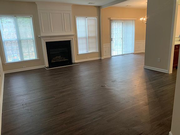 Living area is connected to formal dinning room, kitchen, and half bath