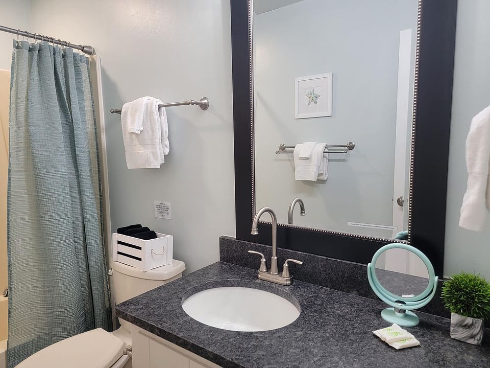 Granite counter, tall faucet, elongated toilet, tub with magnet convertible showerhead.