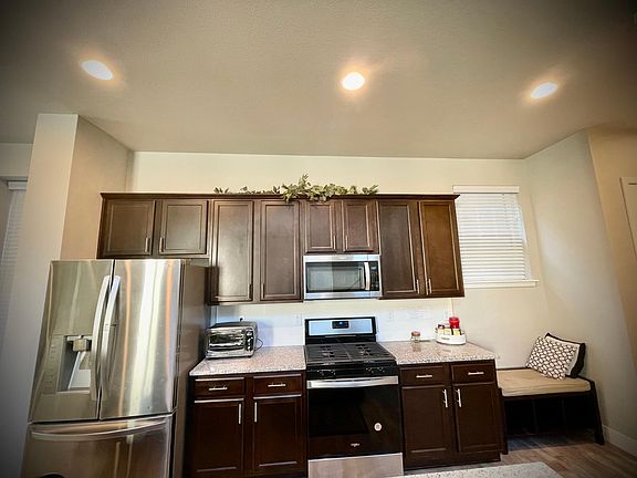 Kitchen area with granite counter top, new appliances.