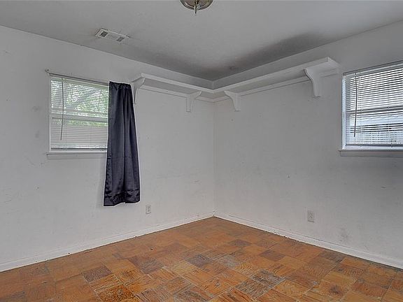 Front bedroom! With wood tile floors, mini blinds for instant privacy. Closet. Built in shelves.