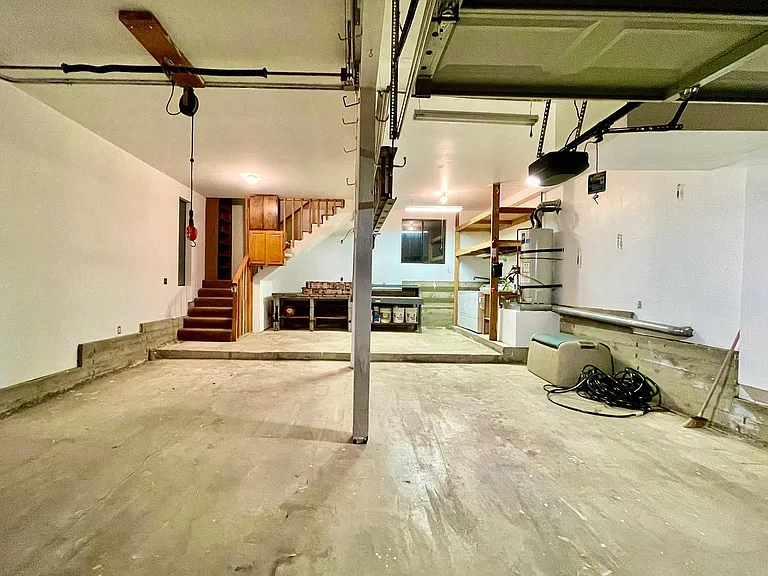 GARAGE WITH ELECTRIC OPENER.
INTERIOR STAIRS FROM GARAGE TO MAIN LEVEL LIVING SPACE