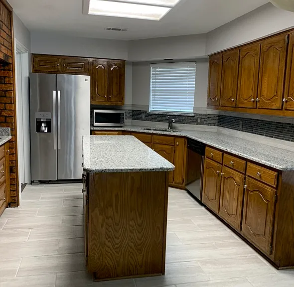 Kitchen with center island with plenty of cabinets, storage, and bay window and breakfast nook not seen in picture.
