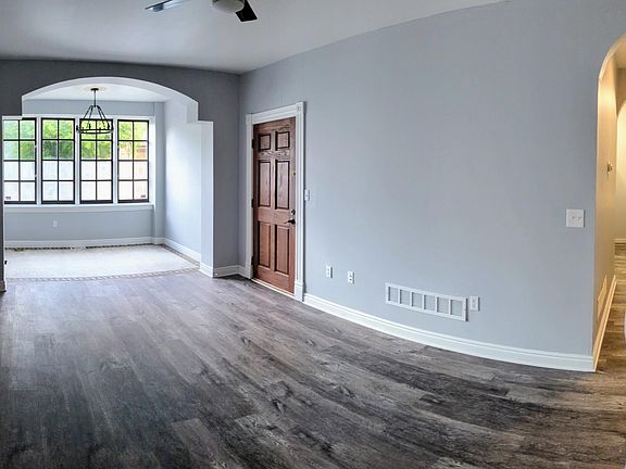 Panoramic shot of living space and hallway to kitchen