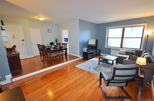 The large sunny, sunken living room has Eastern Exposures and refinished hardwood floors.