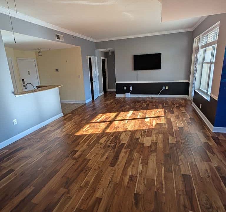 Living room with den/dining area, brand-new blinds, and included wall-mounted Smart TV