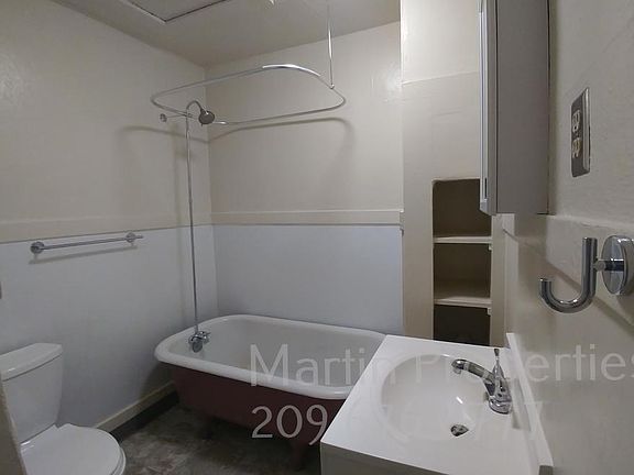 Clawfoot bathtub and shower with circular curtain (not pictured here included.