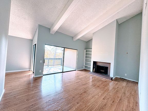 Vaulted Ceilings: Create an open, airy feel with abundant natural light. Spacious Living Area: Perfect for relaxing or entertaining with an inviting fireplace.