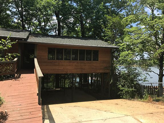 Giant playroom with lake view over carport. Has a foosball