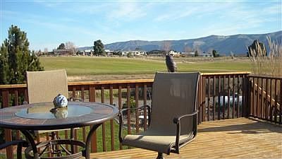 Expansive deck with BBQ, dining area and hot tub.