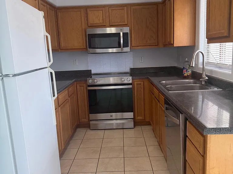 Full galley-style kitchen with plenty of storage and counter space. A new sink and kitchen faucet with a newer dishwasher for your convenience, and standard size refrigerator.