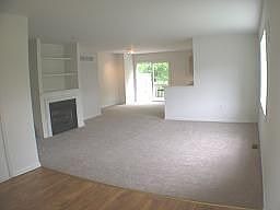 living room with gas fireplace and built-ins, view of eating