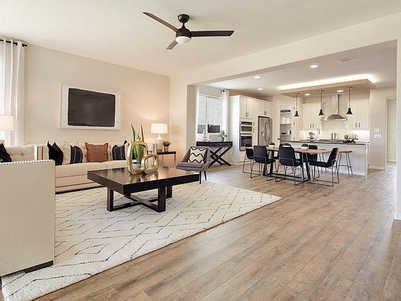 Open home design showing spacious gathering room, cafe, and kitchen